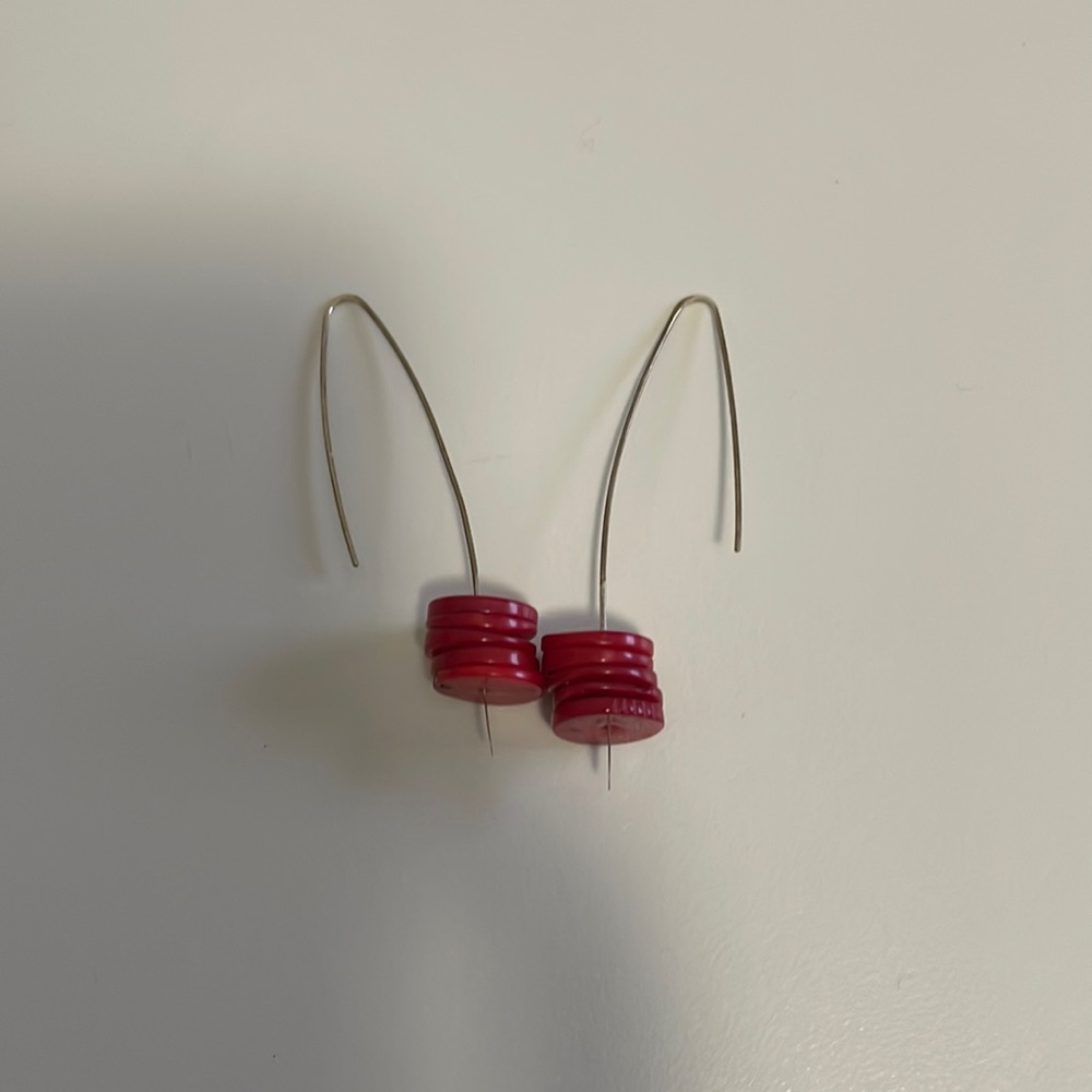 Unusual long pierced earrings with red accents